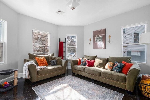 living room featuring baseboards and visible vents