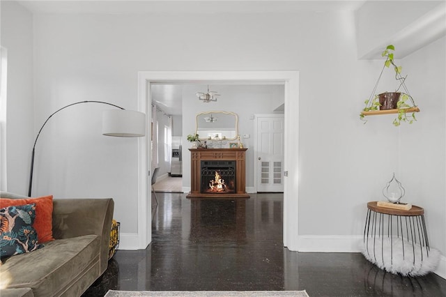 interior space featuring a lit fireplace and baseboards