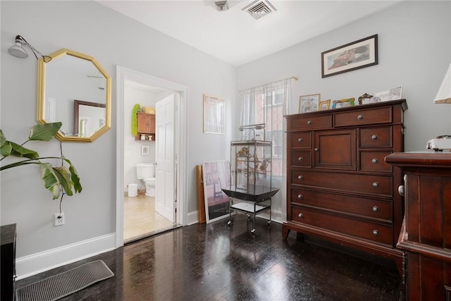 interior space featuring baseboards, visible vents, and wood finished floors