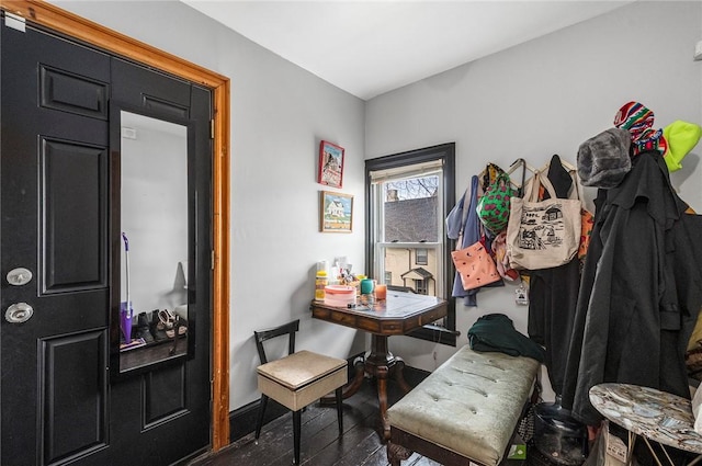 interior space featuring baseboards and wood finished floors