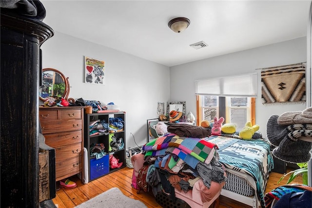 bedroom featuring visible vents and hardwood / wood-style floors