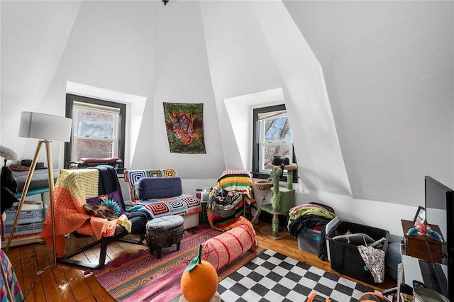 game room featuring hardwood / wood-style flooring and high vaulted ceiling