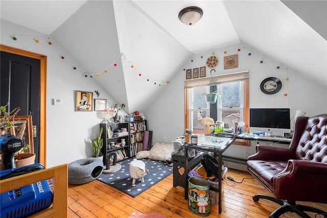 home office with lofted ceiling and hardwood / wood-style flooring