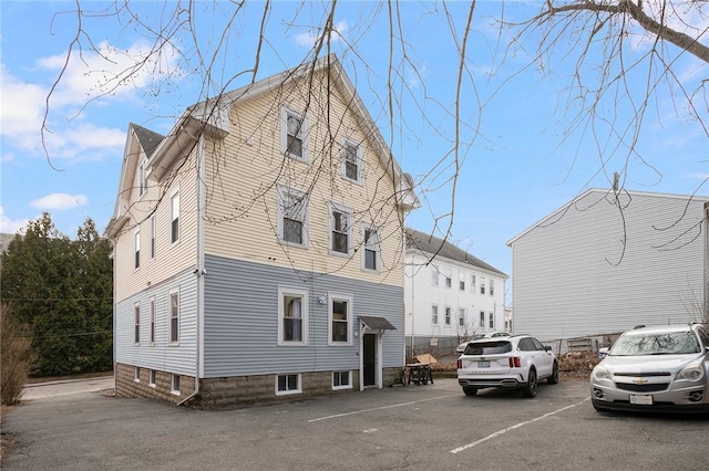 view of property featuring uncovered parking