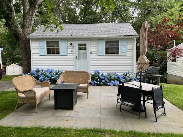 view of patio featuring an outdoor structure and a shed