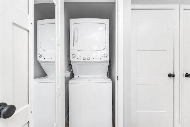 washroom featuring laundry area and stacked washer and clothes dryer