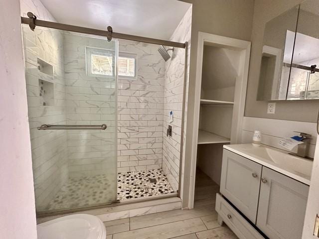 full bath with a stall shower and vanity