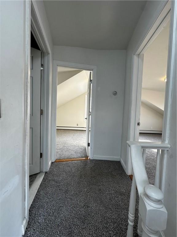 hall with carpet floors, a baseboard radiator, and baseboards