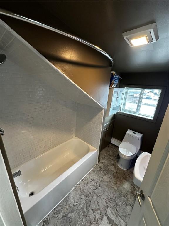 bathroom with marble finish floor and toilet