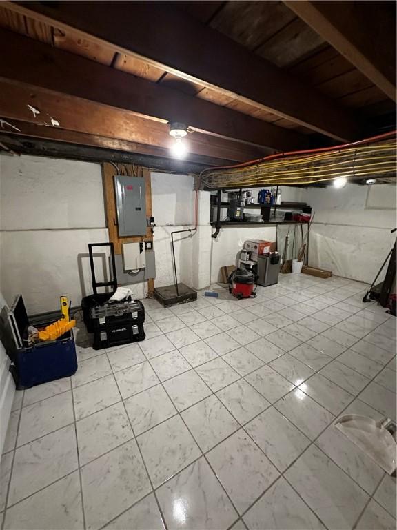 unfinished basement featuring electric panel