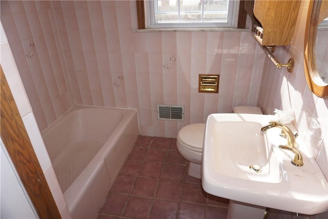 full bath with tile walls, visible vents, toilet, tile patterned flooring, and a bath