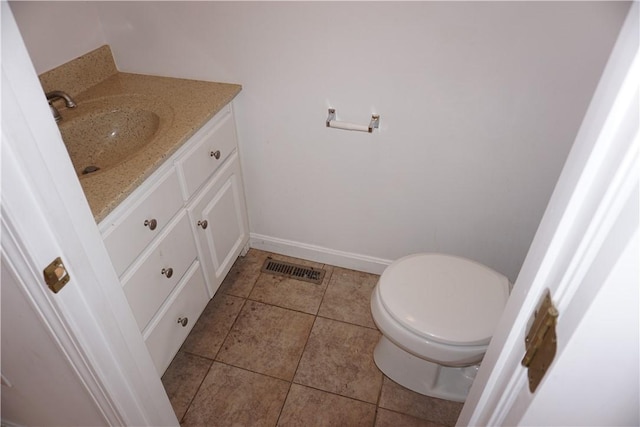 bathroom with visible vents, baseboards, toilet, tile patterned flooring, and vanity