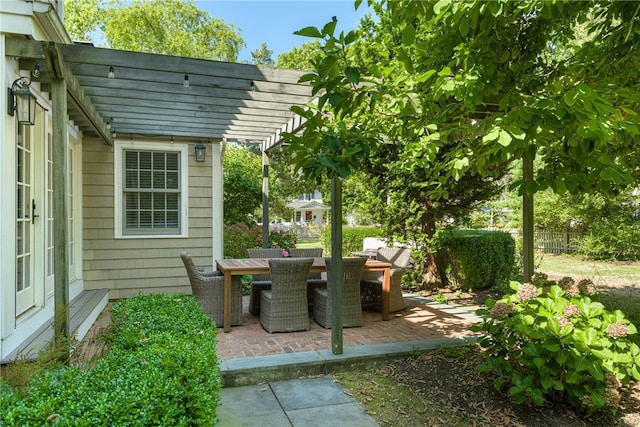 view of patio / terrace with outdoor dining area, fence, and a pergola