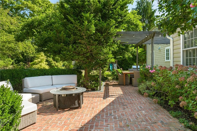 view of patio / terrace with an outdoor living space with a fire pit and a pergola