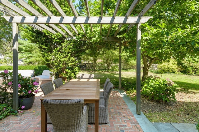 view of patio with outdoor dining space, fence, and a pergola