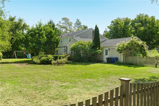 view of yard featuring fence and a playground