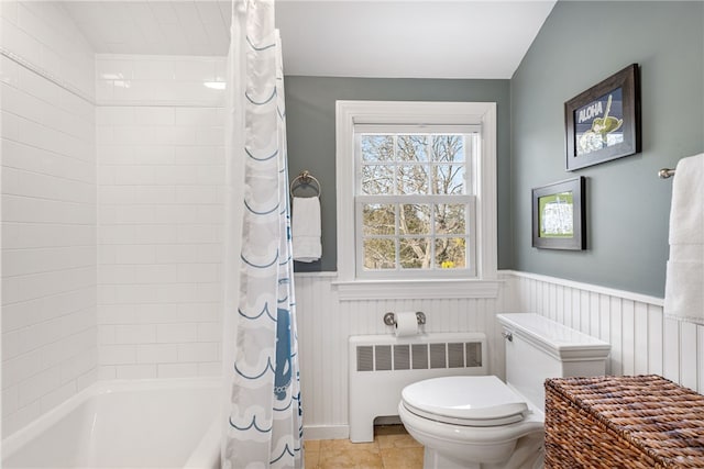 full bathroom featuring a wainscoted wall, shower / bath combination with curtain, radiator, and toilet