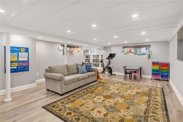 living room with recessed lighting, light wood-style flooring, and baseboards