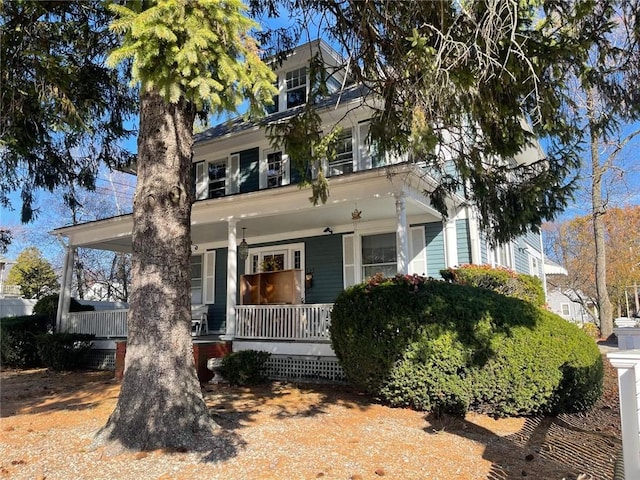 american foursquare style home with a porch