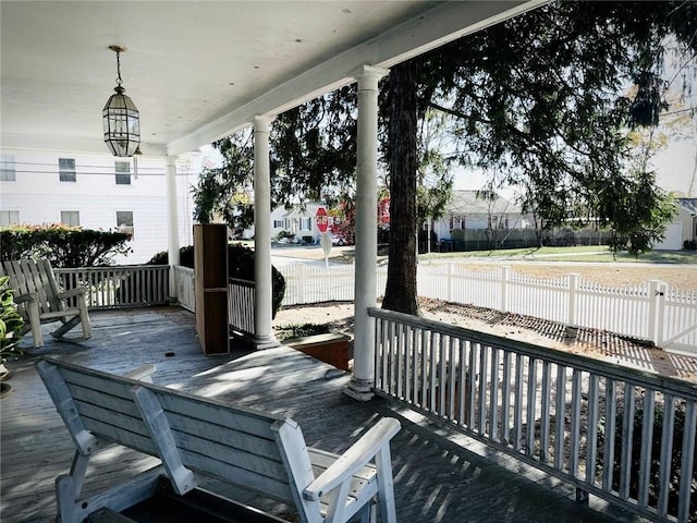 deck with covered porch and fence