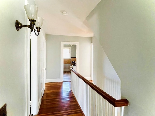 corridor with dark wood-style floors and baseboards