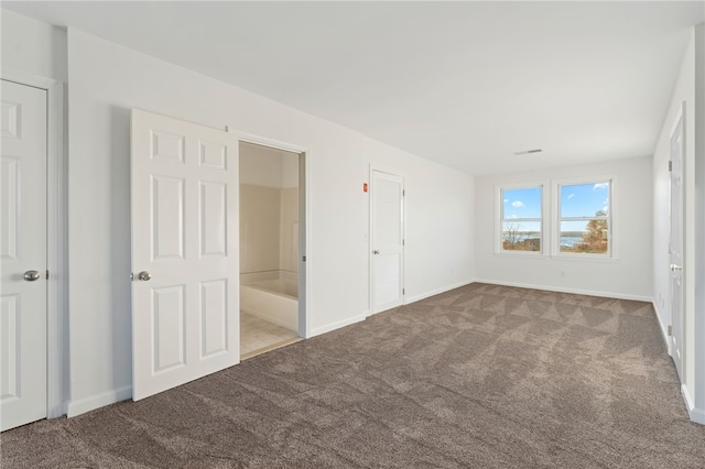 unfurnished bedroom featuring carpet floors and baseboards