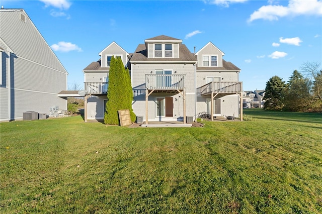 rear view of property with a yard, cooling unit, and a patio