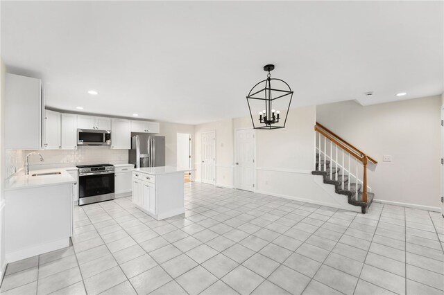 704 Fairway Dr Unit 704, Middletown, RI 02842 - kitchen with appliances with stainless steel finishes, a sink, light countertops, a chandelier, and recessed lighting