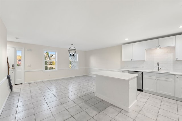 kitchen featuring light countertops, a sink, dishwasher, and light tile patterned floors