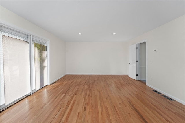 unfurnished room with visible vents, recessed lighting, light wood-style flooring, and baseboards