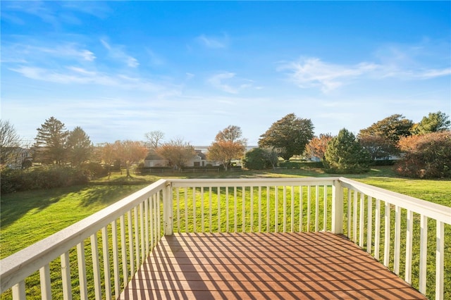 wooden terrace featuring a yard