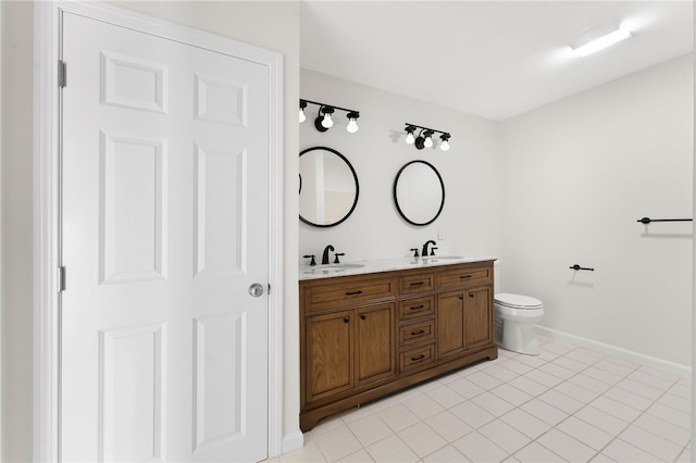 bathroom featuring double vanity, a sink, and tile patterned floors