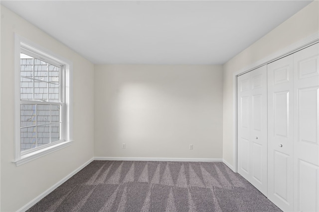 704 Fairway Dr Unit 704, Middletown, RI 02842 - unfurnished bedroom with carpet floors, baseboards, multiple windows, and a closet