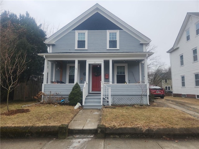 view of front of property with covered porch and fence