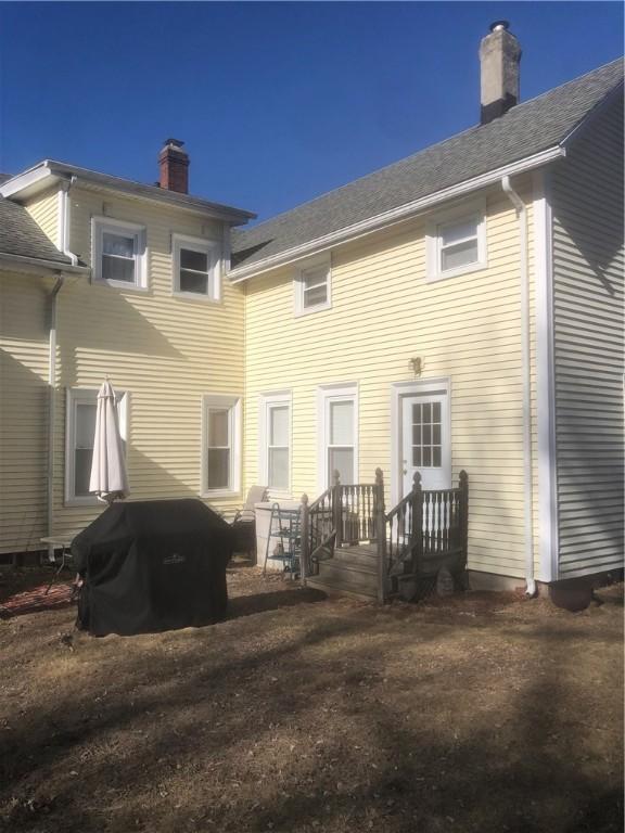 back of property featuring a chimney