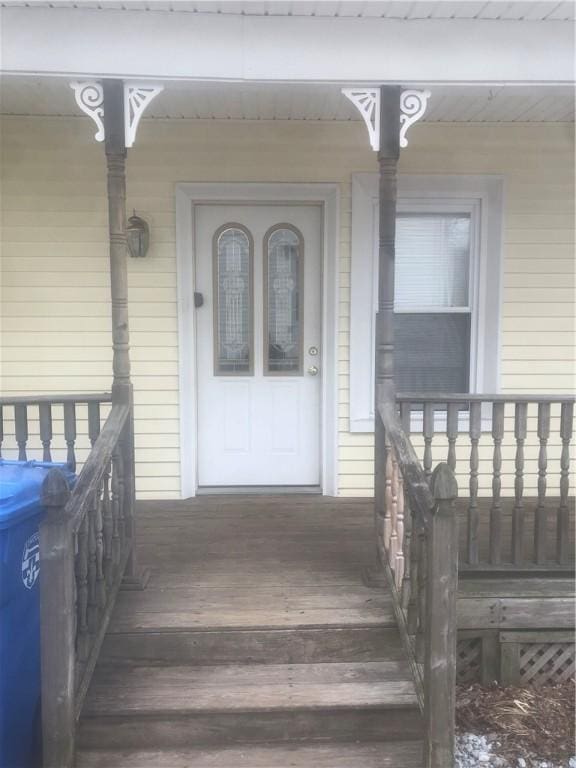 view of exterior entry featuring a porch