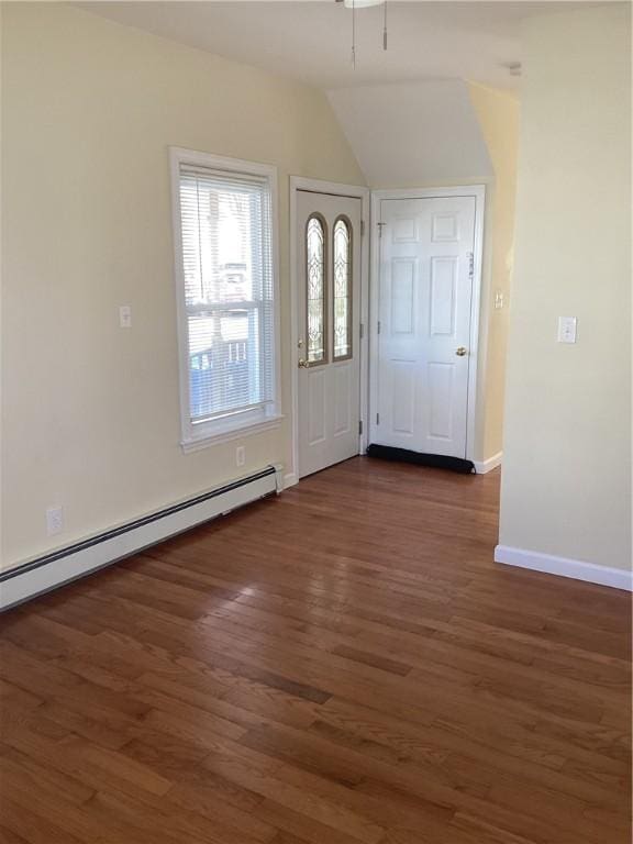 entrance foyer featuring lofted ceiling, baseboard heating, dark wood finished floors, and baseboards