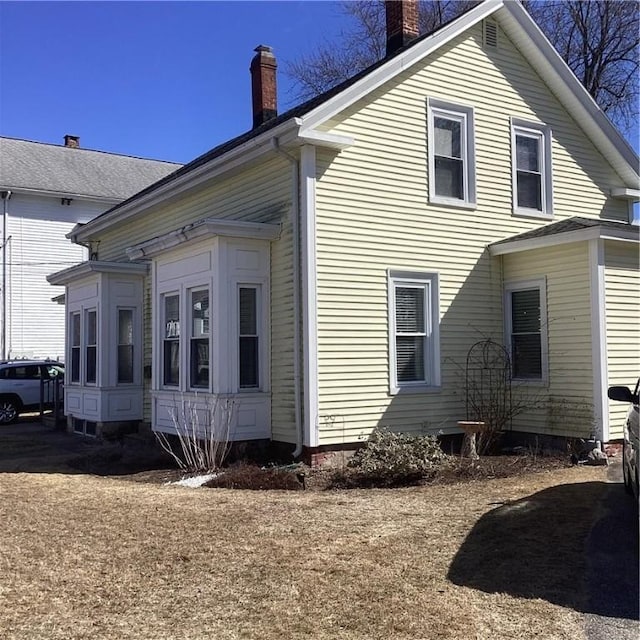 view of home's exterior with a chimney