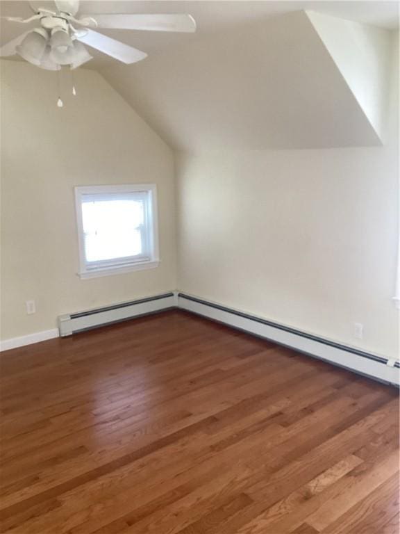 bonus room featuring a ceiling fan, a baseboard radiator, wood finished floors, baseboard heating, and vaulted ceiling