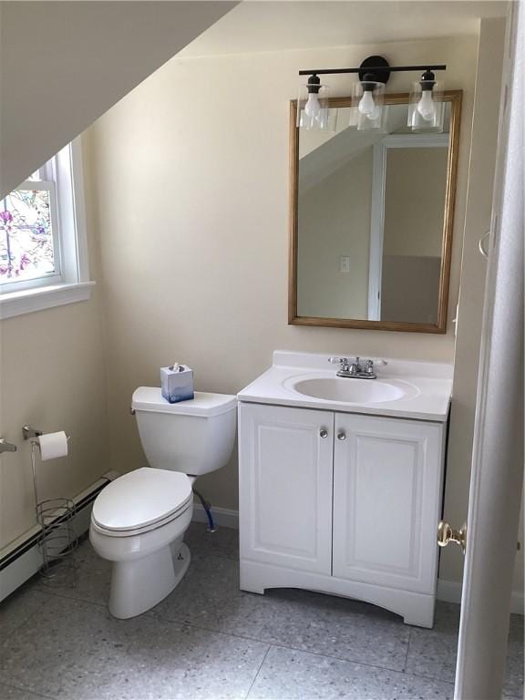 half bathroom with tile patterned floors, vanity, toilet, and baseboards