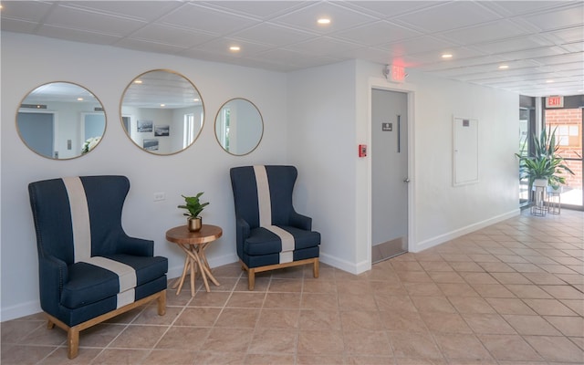 sitting room featuring light tile patterned flooring, baseboards, and recessed lighting