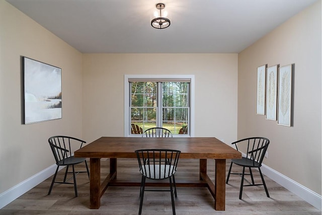 dining area featuring baseboards and wood finished floors