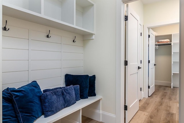 mudroom with baseboards and light wood finished floors