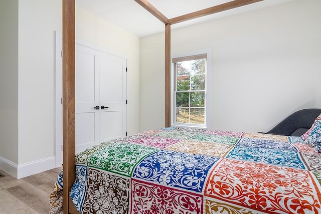 bedroom with baseboards and wood finished floors