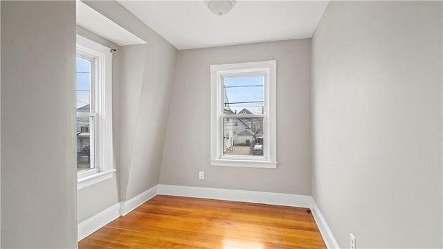 unfurnished room with light wood-style floors and baseboards