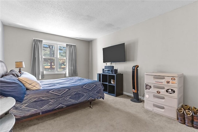 carpeted bedroom featuring baseboards and a textured ceiling