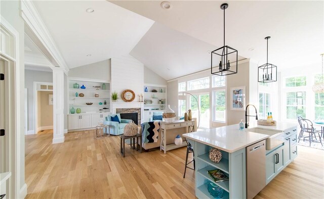 168 Explorer Dr, North Kingstown, RI 02874 - kitchen with light wood finished floors, dishwasher, a stone fireplace, open shelves, and a sink
