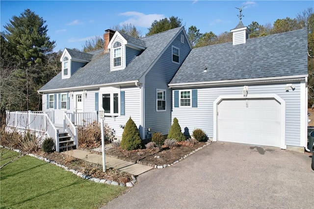 cape cod house featuring a garage, a shingled roof, a chimney, aphalt driveway, and a front lawn