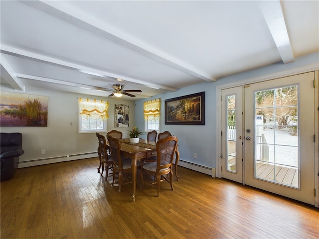 dining space with a wealth of natural light, a baseboard radiator, and beamed ceiling