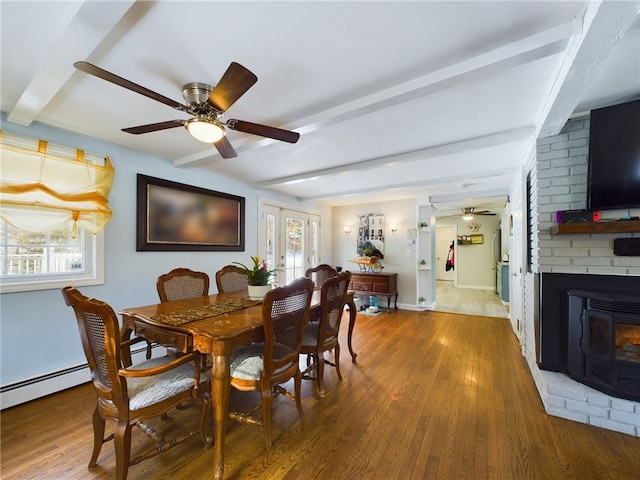 dining area with a ceiling fan, baseboard heating, beamed ceiling, and wood finished floors